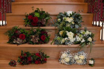 Flower bouquets arranged on wooden stairs