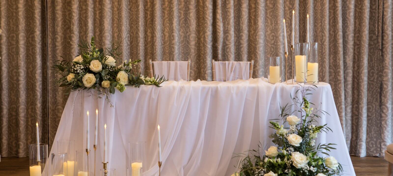 Wedding table with candles and flower displays