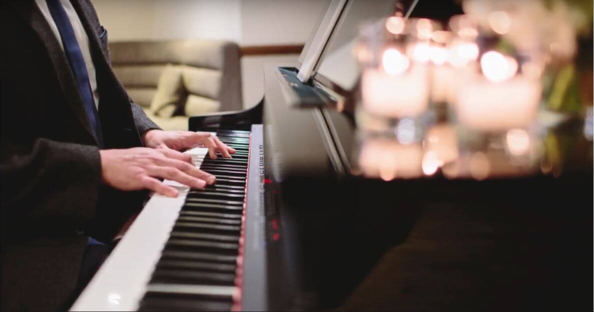 Close of piano keyboard with hands