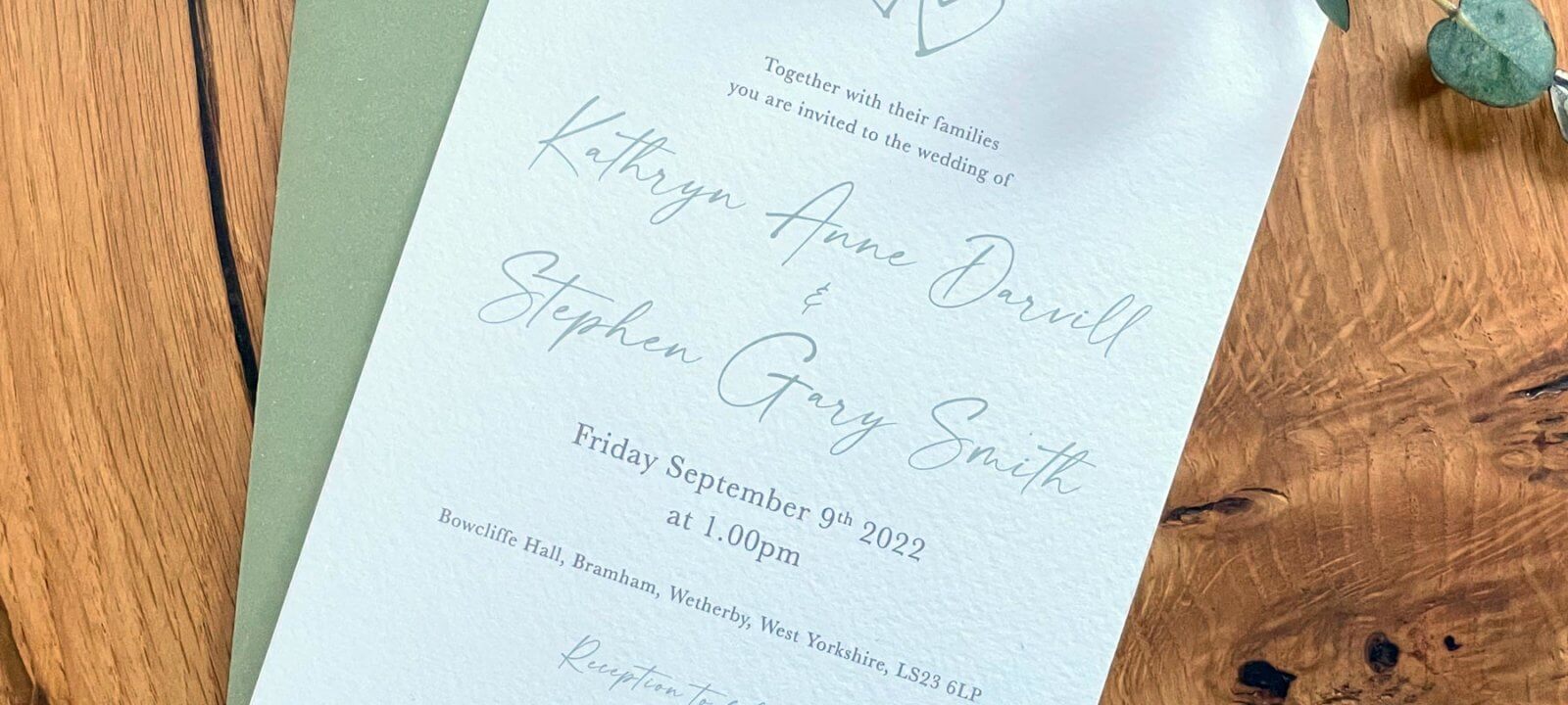 Wedding invitation card on wooden table