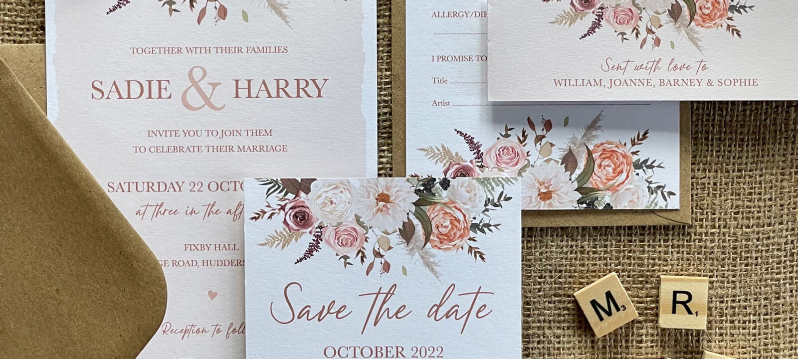 Selection of wedding stationery including save the date card and invitation