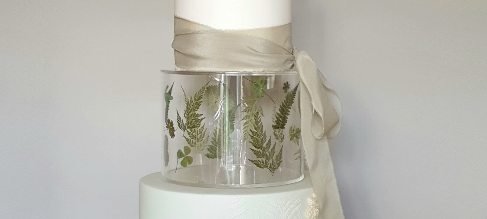 Tiered wedding cake with ribbon