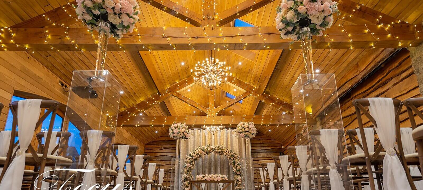 wedding ceremony room decorated with flowers and fairy lights