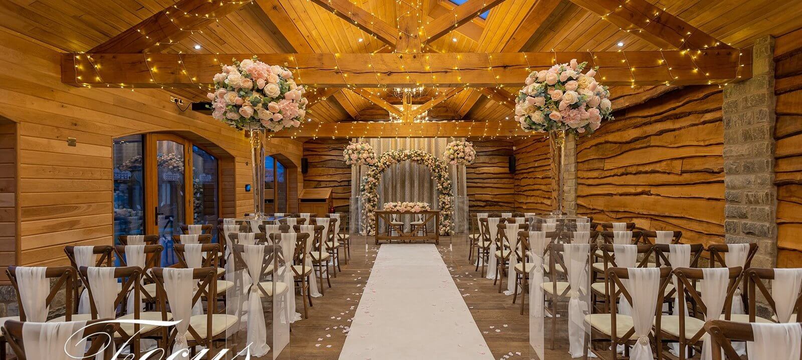 wedding ceremony room decorated with flowers and fairy lights