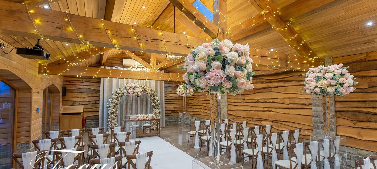 wedding ceremony room decorated with flowers and fairy lights